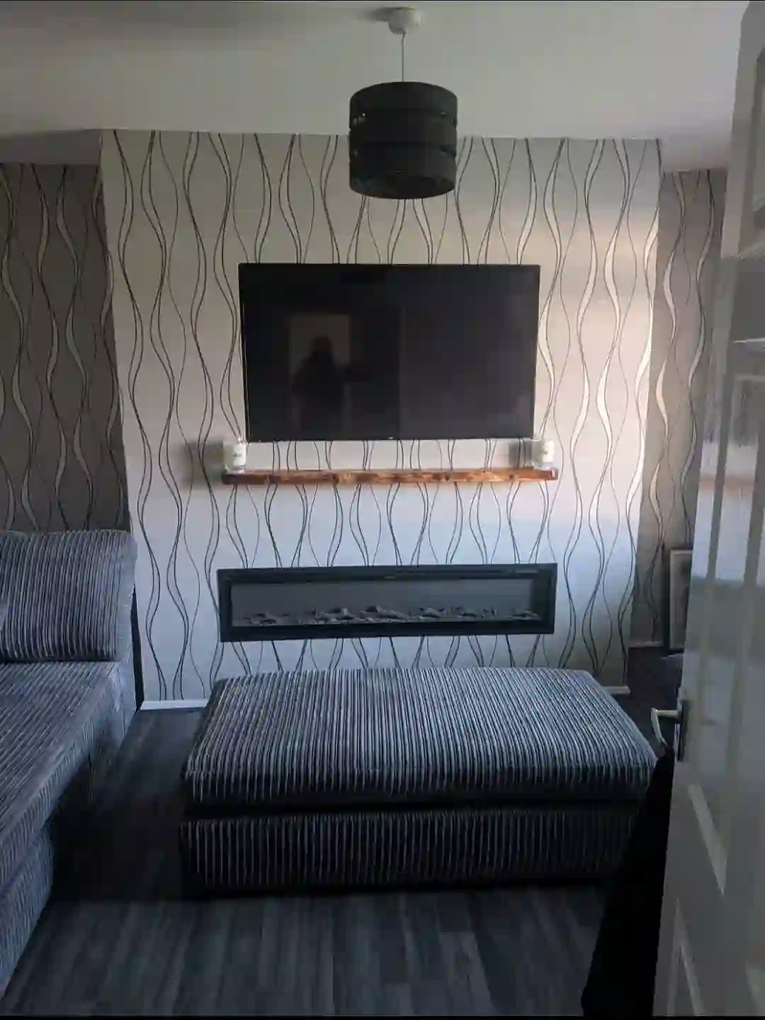 Finished media wall with mounted TV and fireplace by GTH Maintenance Manchester