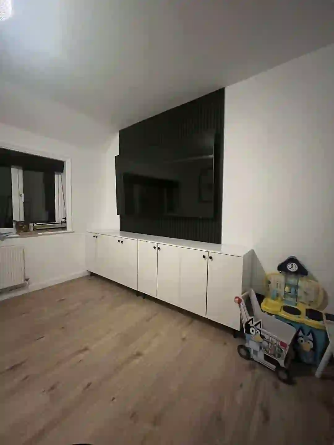 Living room media unit and new flooring in Manchester